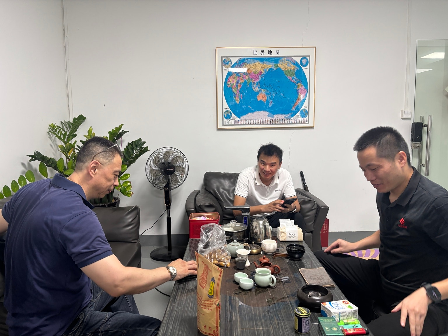Chinese factory owners sharing tea during a business meeting with the Sauce Asia team in China.