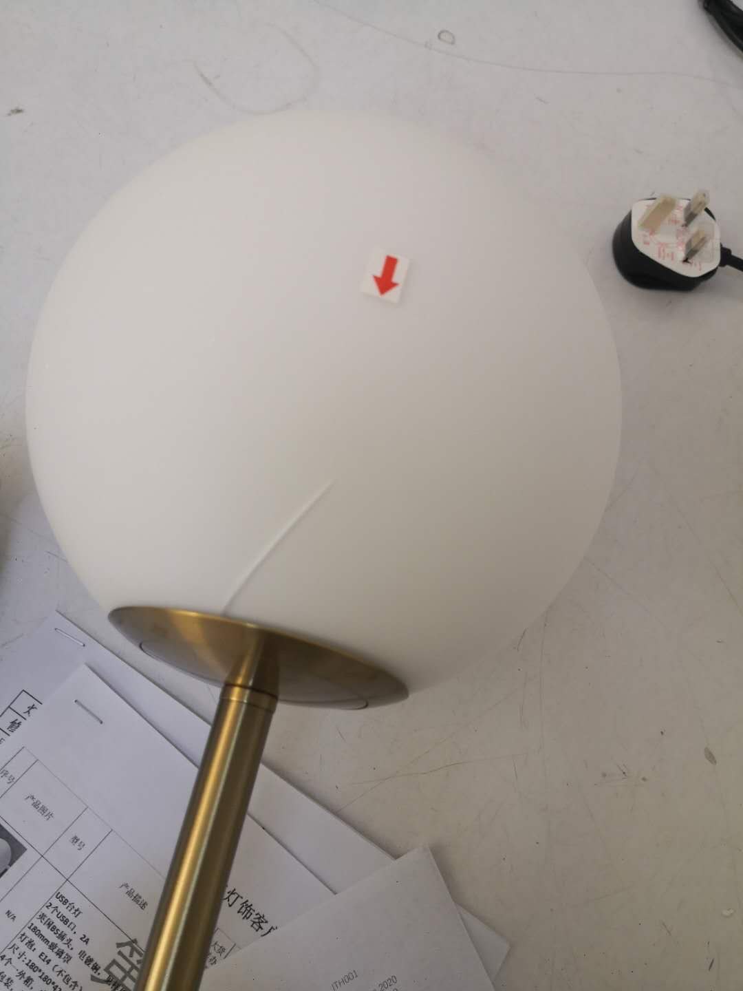 Glass globe defect marked during pre-shipment inspection