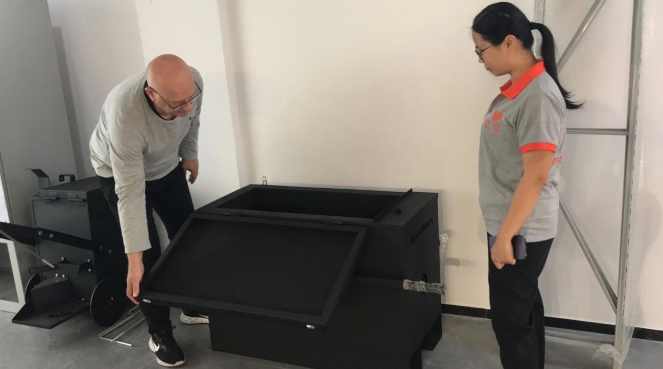 Colin Moore and a colleague inspecting manufactured equipment at a Chinese factory